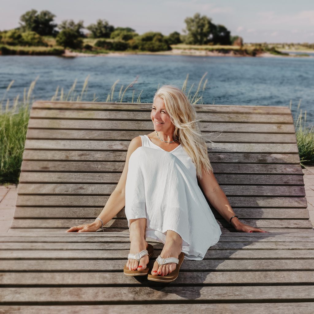 Ich sitze am Strand und genieße den Blick in die Weite.