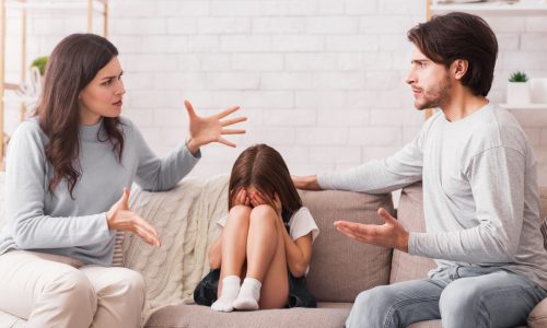 Streitende Eltern, Kind sitzt mittig dazwischen